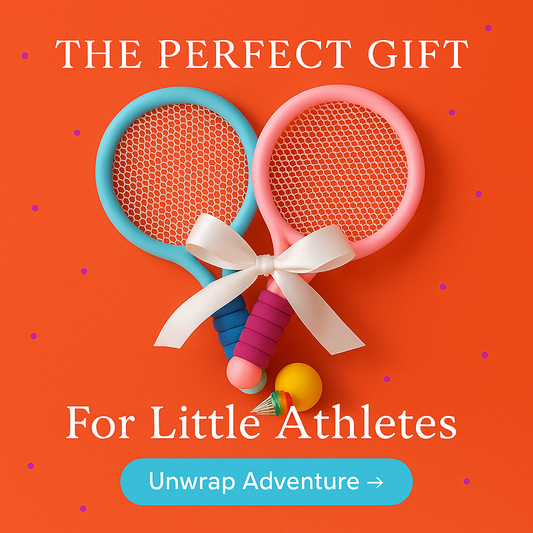 Two child-sized badminton-style racquets—one pastel blue, one pastel pink—with foam-wrapped handles, arranged criss-cross on a color-blocked background alongside a bright yellow foam ball and a rainbow-striped shuttlecock.